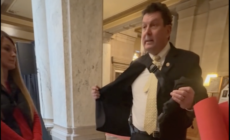 Rep. Jim Lucas, R-Seymour, opened his coat and flashed a handgun to a group of high school students at the Indiana Statehouse Tuesday after Moms Demand Action Advocacy Day. Screenshot by Kyra Howard, TheStatehouseFile.com.